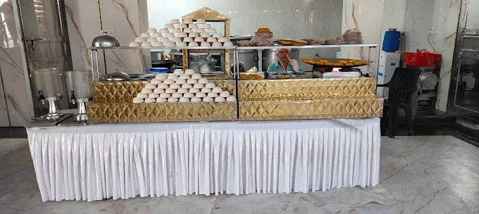 White skirted buffet counter by Shree Balaji Caterers